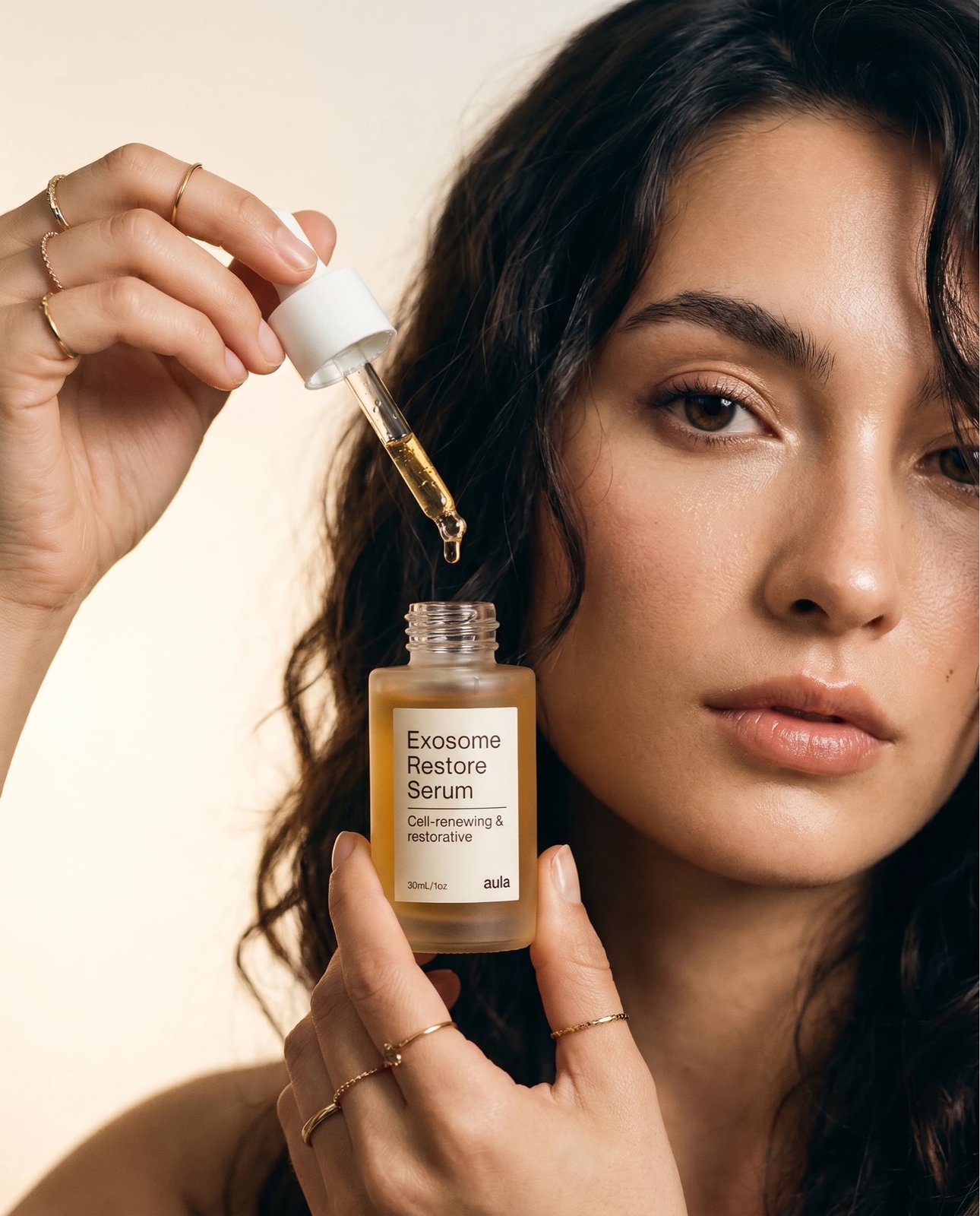 Model applying Exosome Restore Serum with the dropper